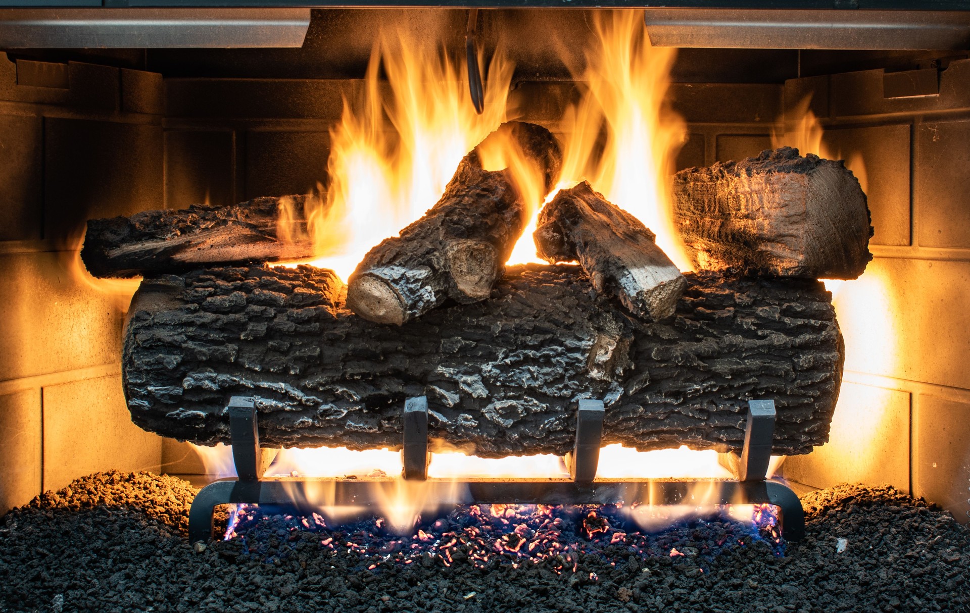 Fire burning in gas fireplace with ceramic simulated logs
